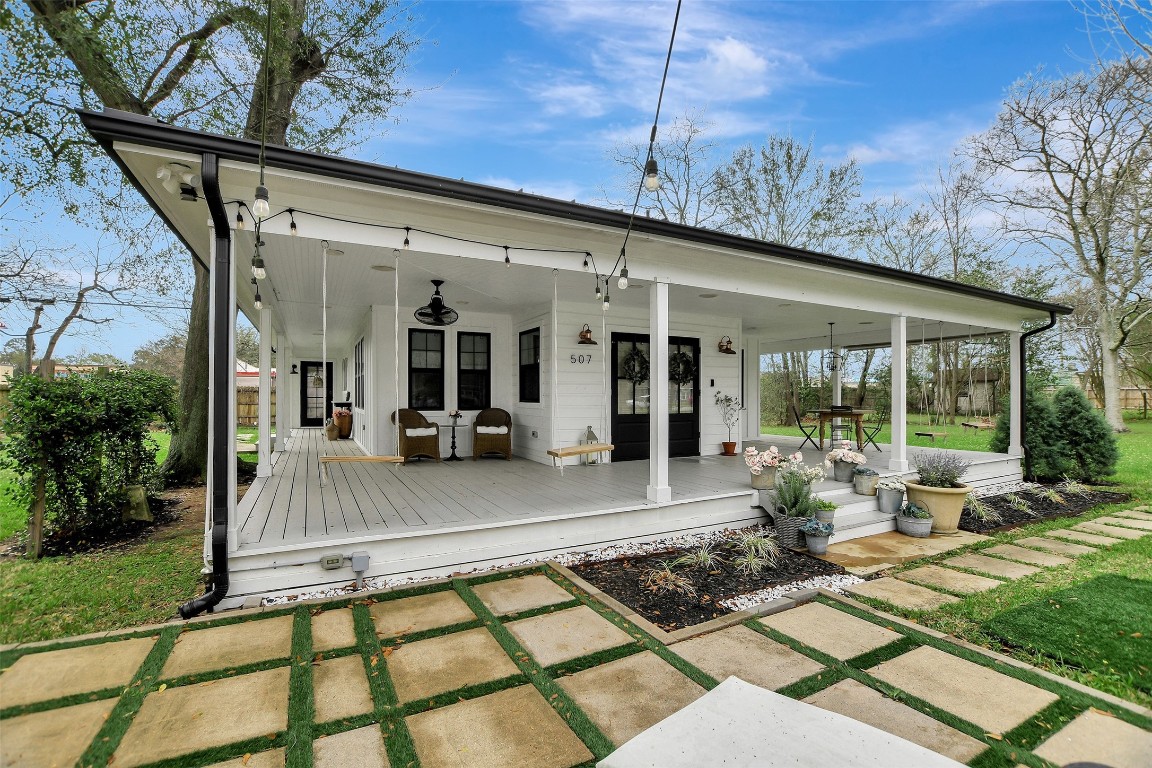 507 Mason Street Tomball, TX 77375 - Photo 3 of 24 a view of a patio with chairs and floor to ceiling window
