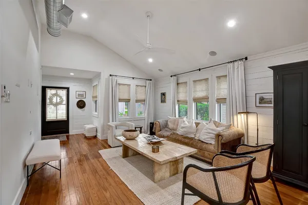 a living room with furniture and wooden floor