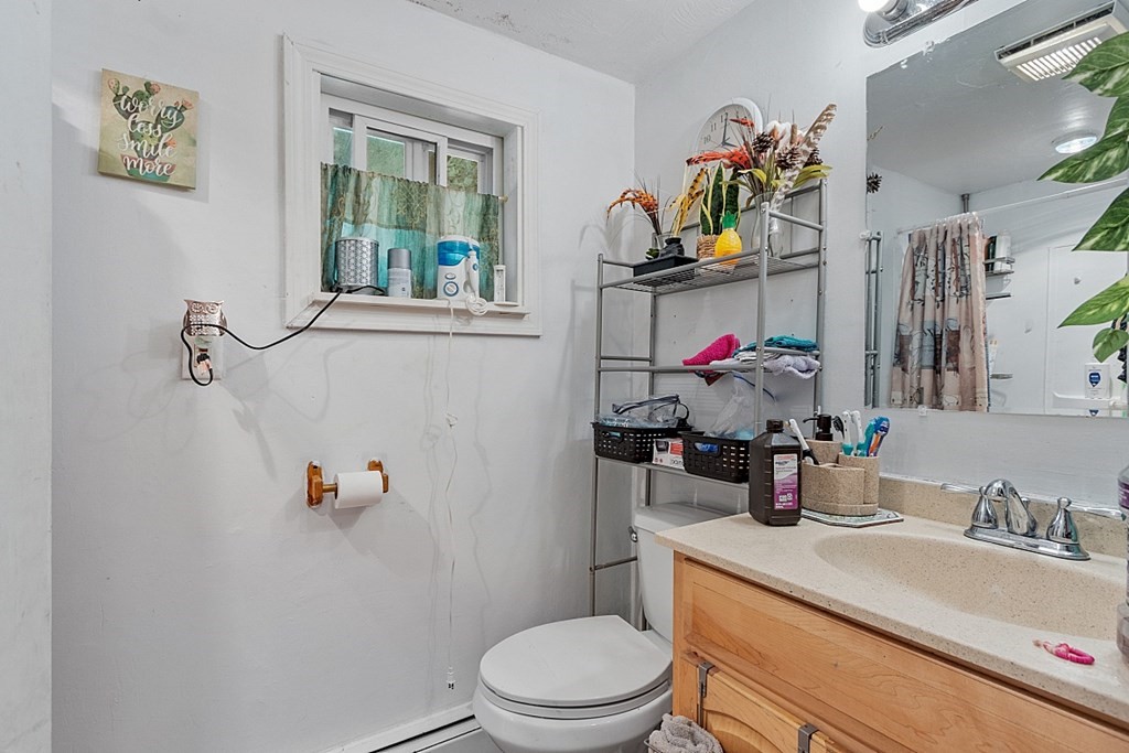 55 Sylvan Road Lancaster, MA 01523 - Photo 13 of 22 a bathroom with a sink mirror vanity and toilet