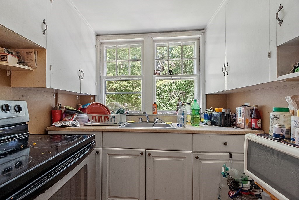 55 Sylvan Road Lancaster, MA 01523 - Photo 18 of 22 a kitchen with stainless steel appliances a sink a stove and a window