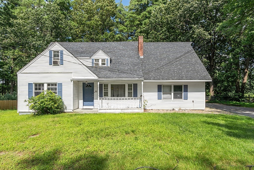 55 Sylvan Road Lancaster, MA 01523 - Photo 3 of 22 a front view of a house with a yard and trees