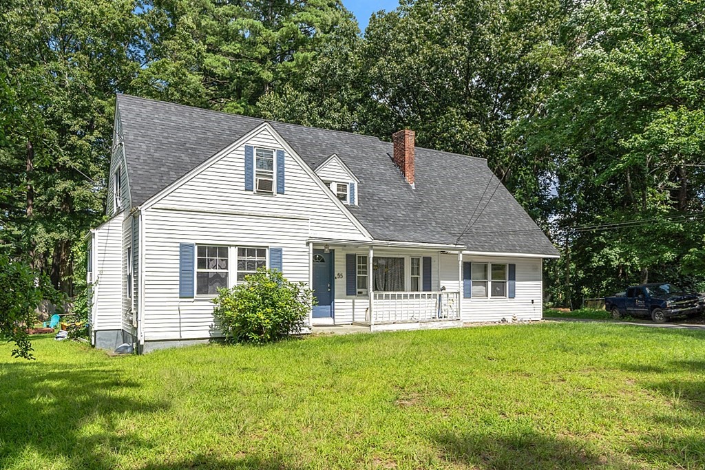 55 Sylvan Road Lancaster, MA 01523 - Photo 4 of 22 a front view of a house with yard and green space