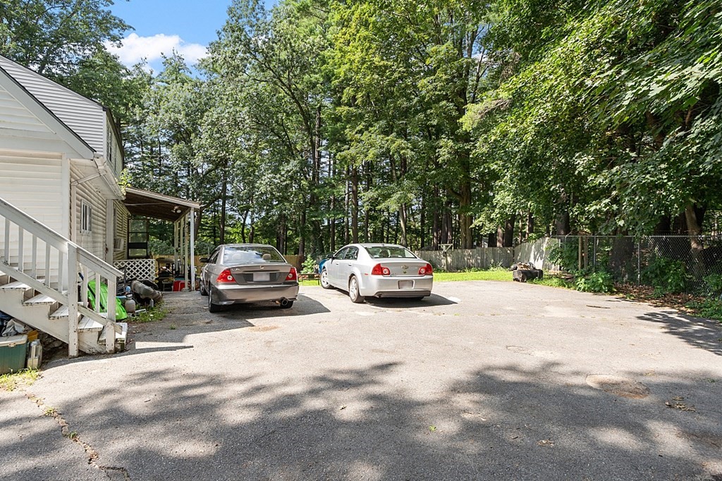 55 Sylvan Road Lancaster, MA 01523 - Photo 5 of 22 a view of car parked on the side of road