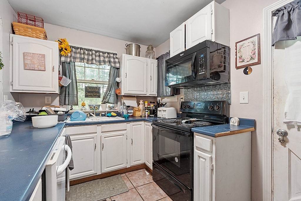 55 Sylvan Road Lancaster, MA 01523 - Photo 10 of 22 a kitchen with stainless steel appliances a sink stove and cabinets
