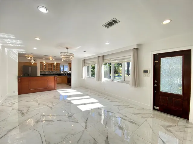 a view of a bedroom with a bed and a window