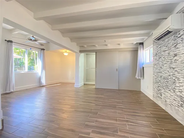 a kitchen with granite countertop a stove top oven cabinetry a sink and a microwave