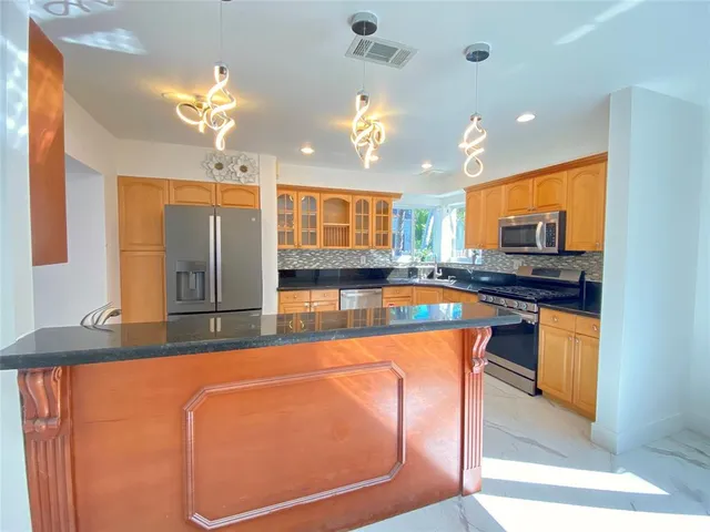 a view of a backyard with wooden fence