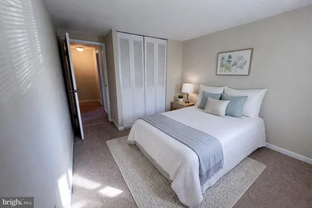 a bedroom with a bed and a mirror