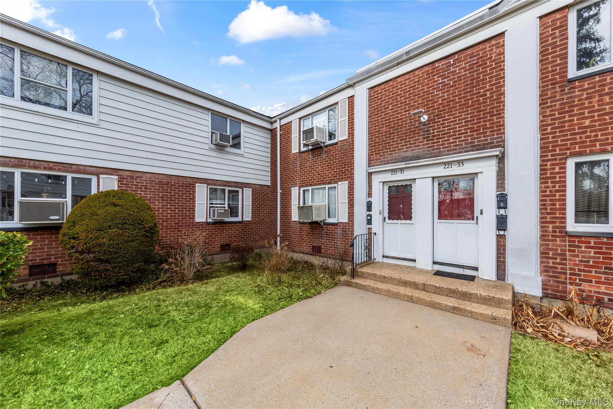 221-31 Braddock Avenue, Unit UPPR Queens, NY 11427 - Photo 2 of 16 a front view of a house with a garden
