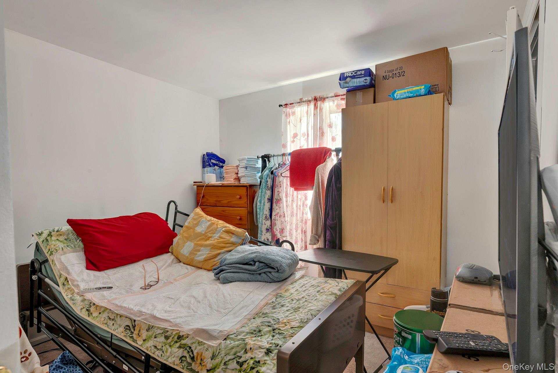 392 Birchwood Road Medford, NY 11763 - Photo 13 of 22 a bedroom with a bed and wooden floor