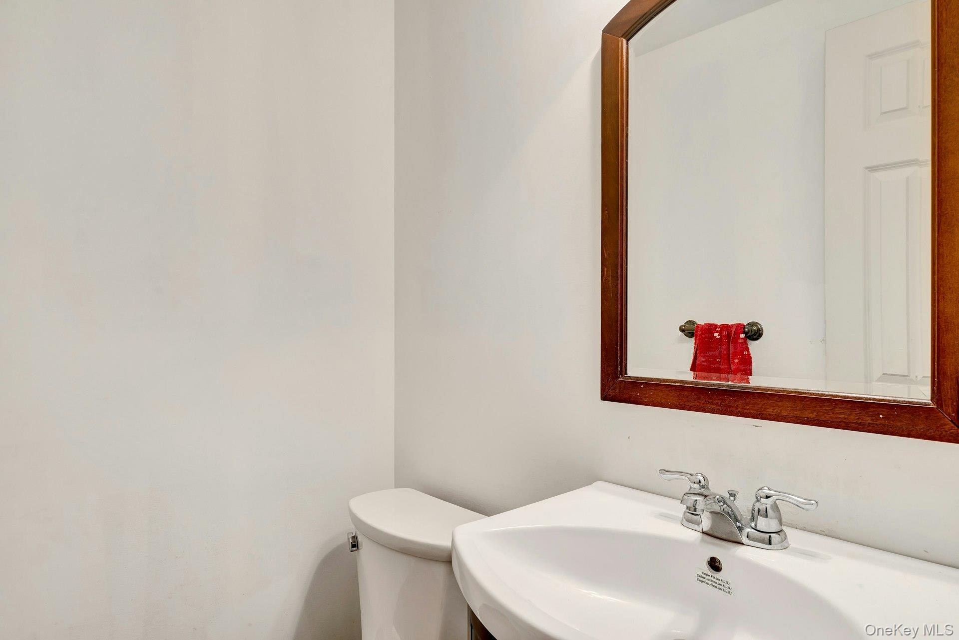 392 Birchwood Road Medford, NY 11763 - Photo 15 of 22 a bathroom with a sink and a toilet