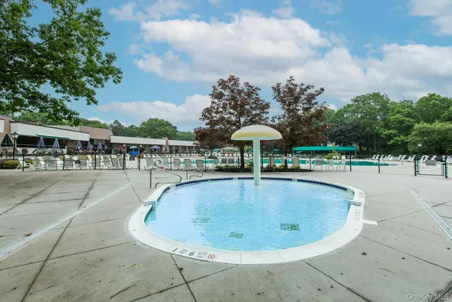 a outdoor view with a swimming pool and furniture
