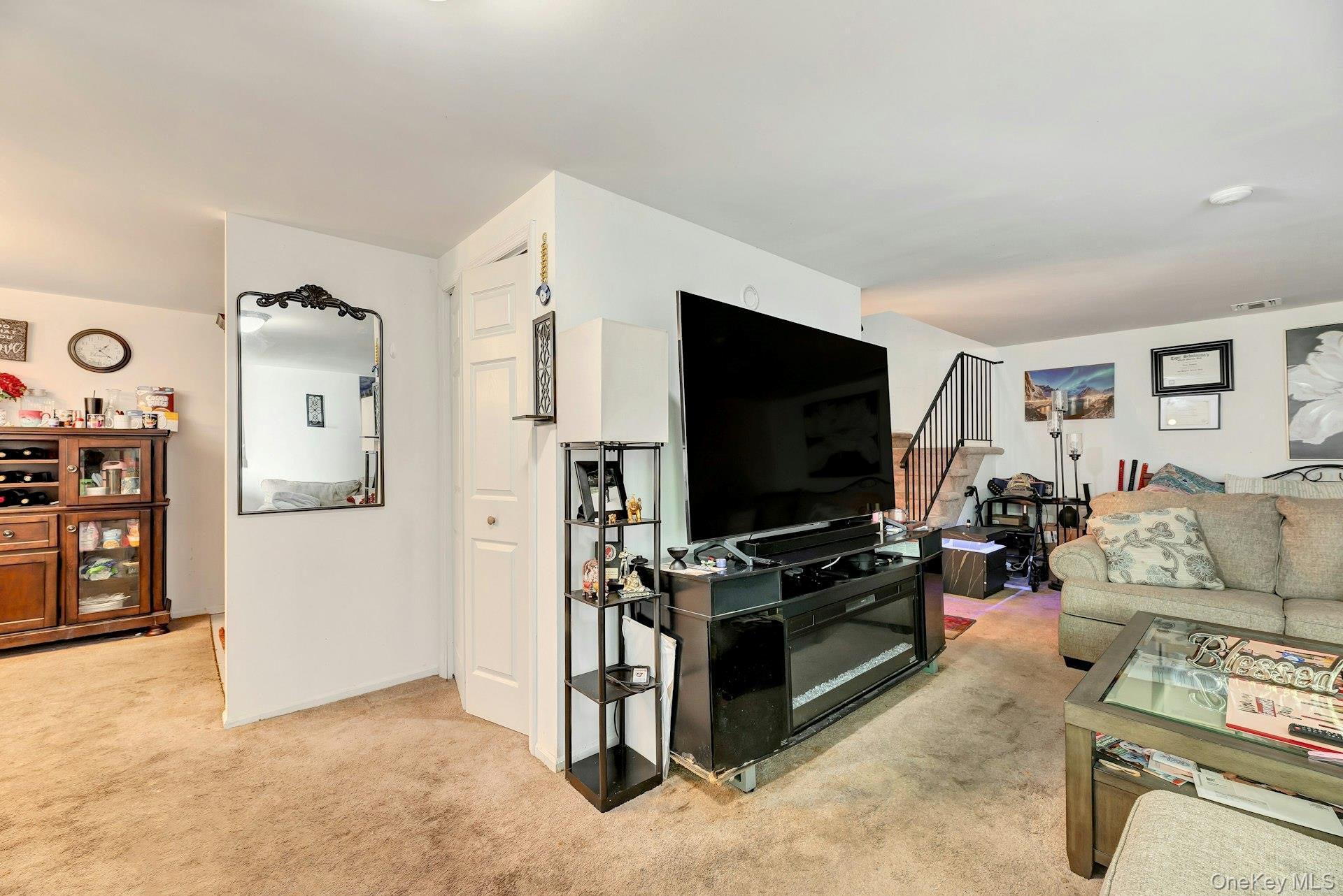 392 Birchwood Road Medford, NY 11763 - Photo 6 of 22 a living room with furniture and a flat screen tv