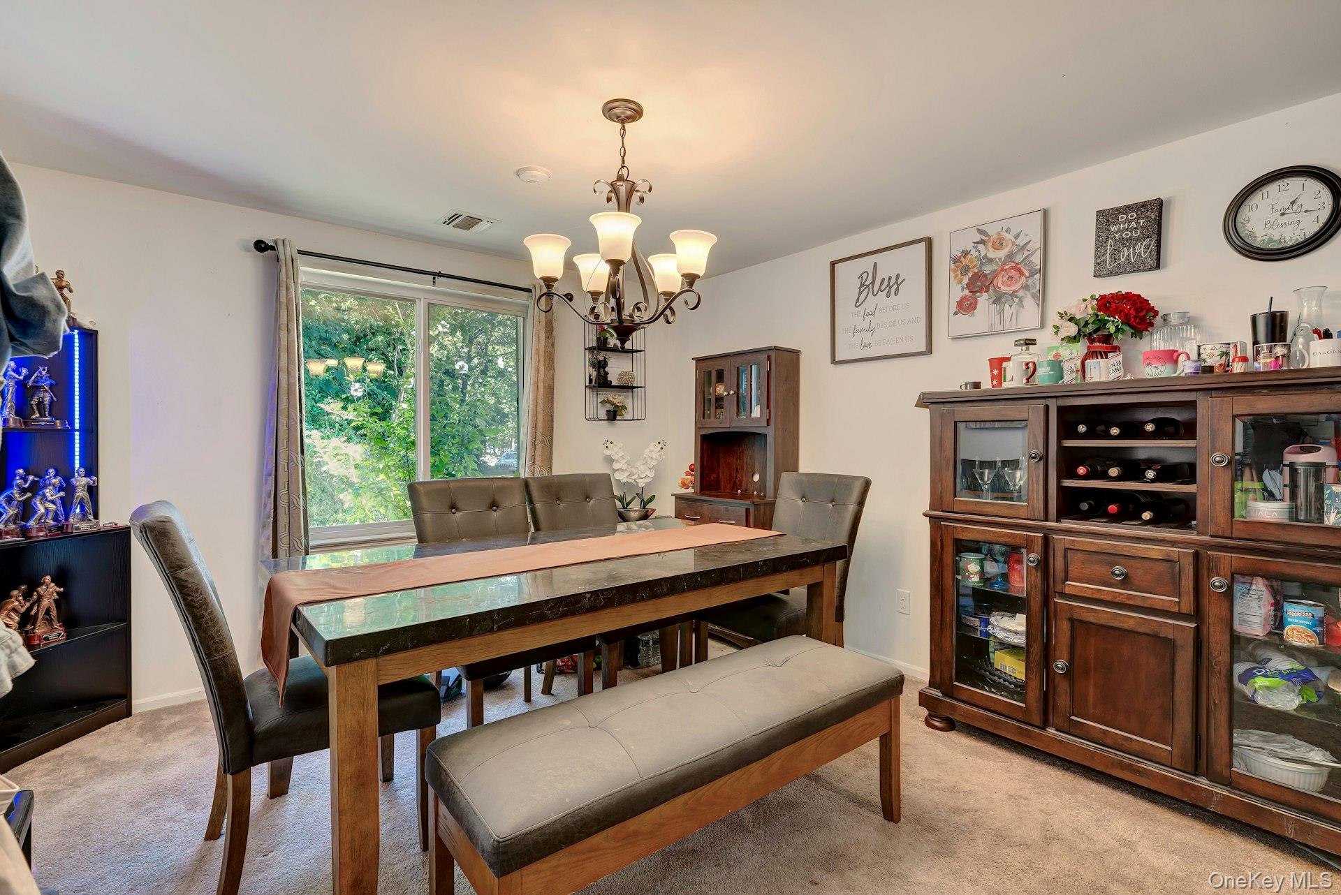 392 Birchwood Road Medford, NY 11763 - Photo 7 of 22 a view of a dining room with furniture a rug and wooden floor