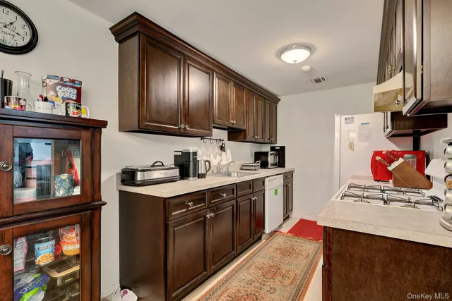 a kitchen with stainless steel appliances granite countertop a stove refrigerator and a sink
