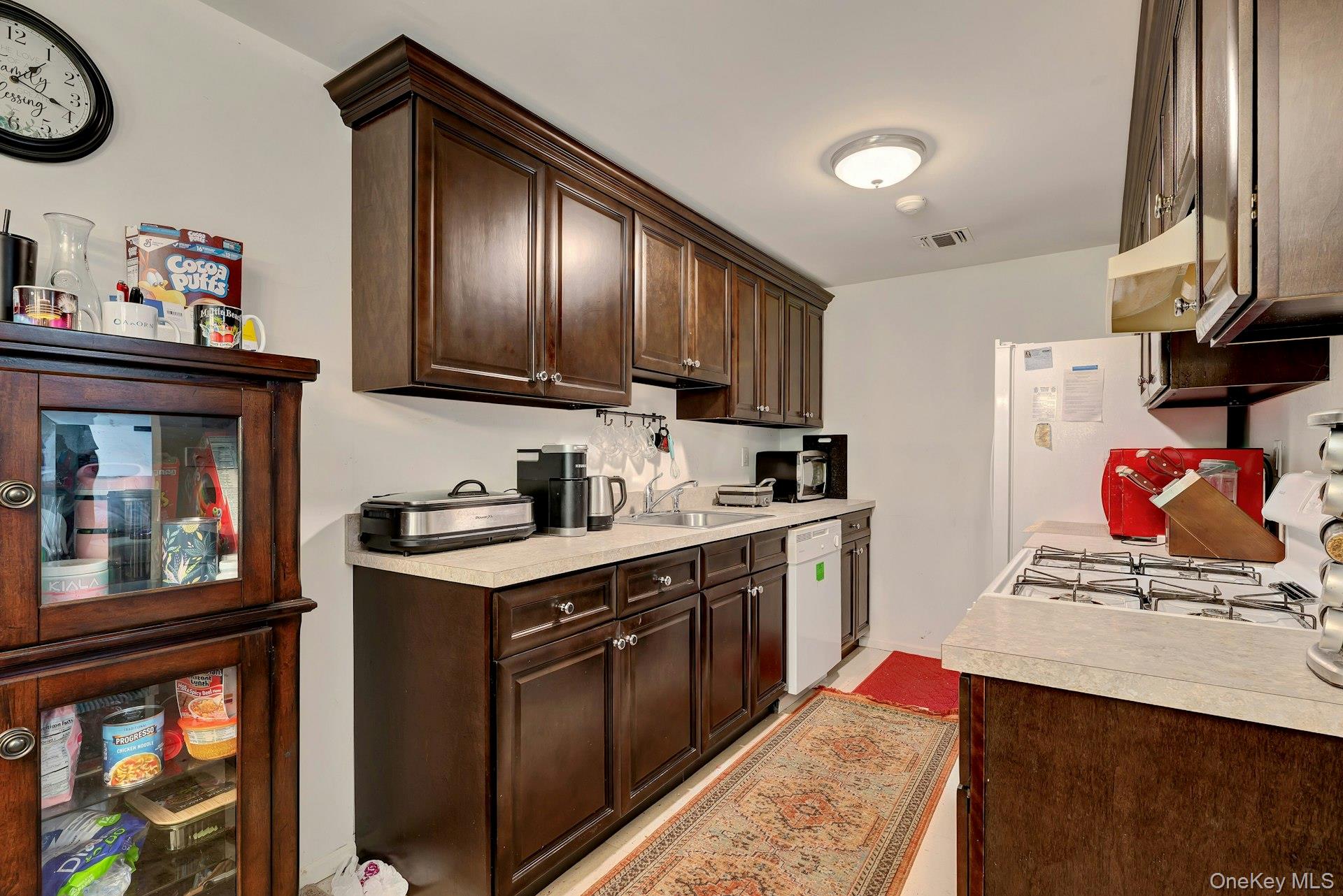 392 Birchwood Road Medford, NY 11763 - Photo 8 of 22 a kitchen with stainless steel appliances granite countertop a stove refrigerator and a sink