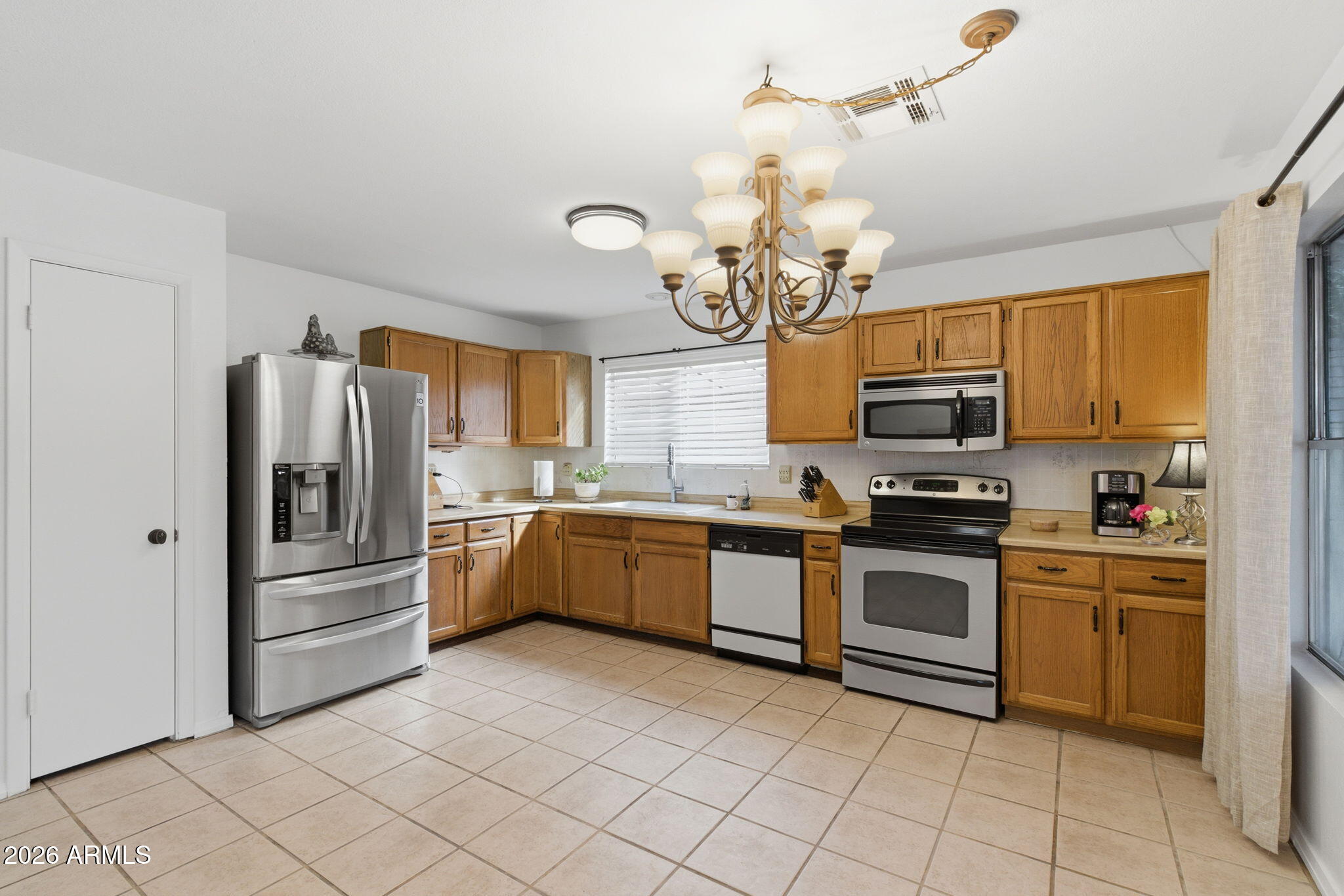 7119 West Ocotillo Road Glendale, AZ 85303 - Photo 12 of 24 a kitchen with a sink stainless steel appliances and cabinets
