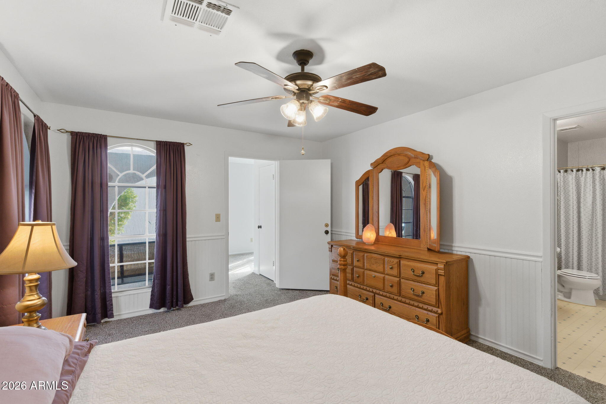 7119 West Ocotillo Road Glendale, AZ 85303 - Photo 15 of 24 a bedroom with a bed dresser and a chandelier