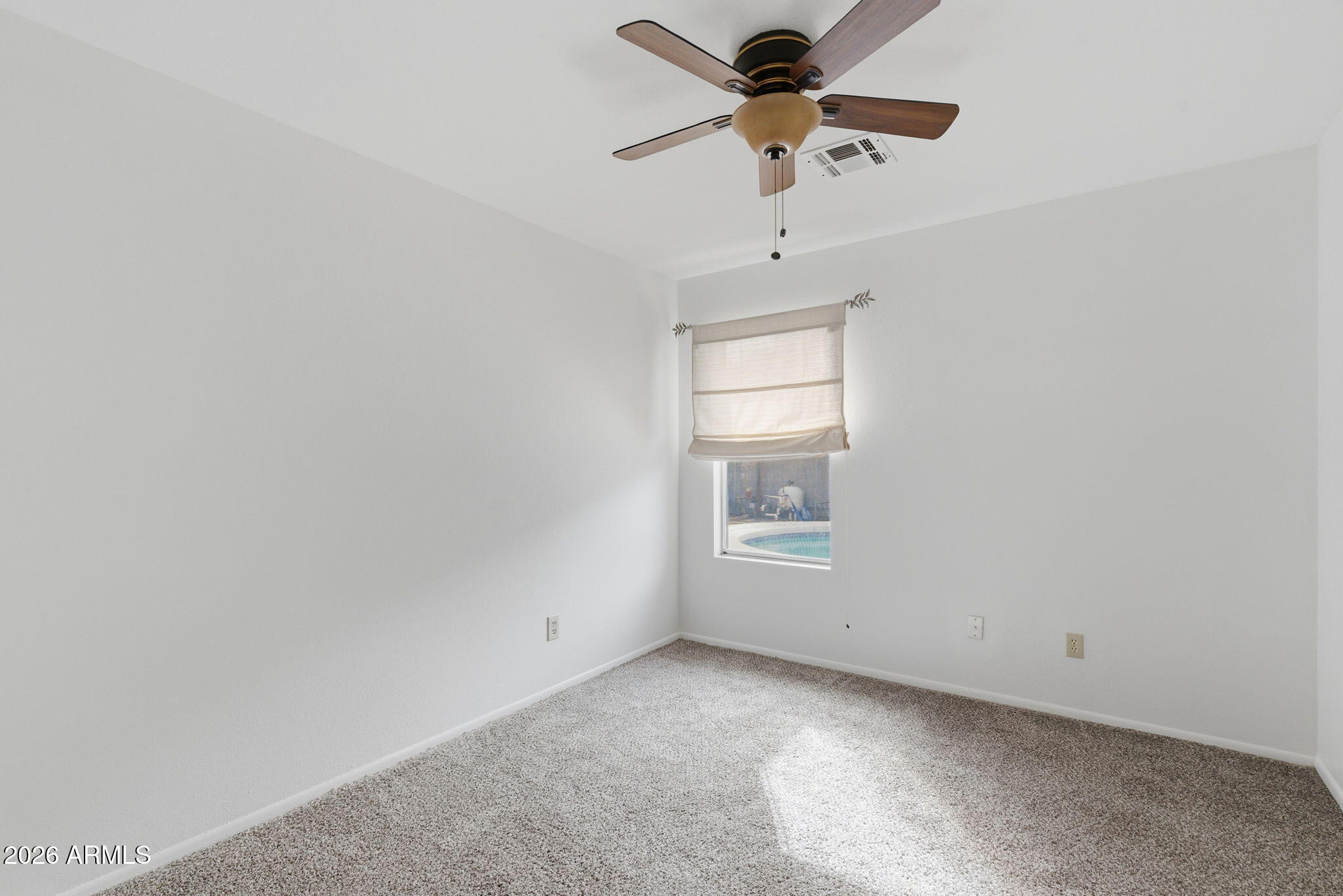 7119 West Ocotillo Road Glendale, AZ 85303 - Photo 19 of 24 an empty room with a window and a fan