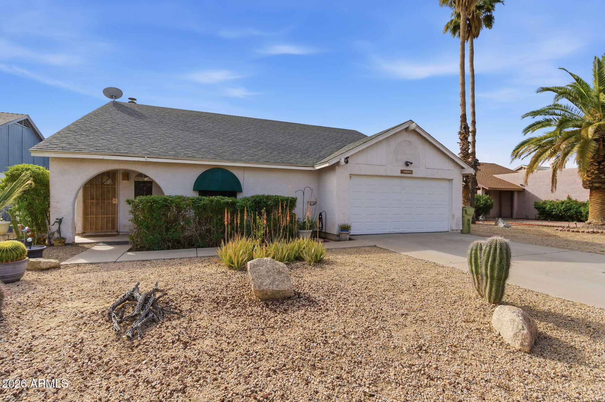 7119 West Ocotillo Road Glendale, AZ 85303 - Photo 2 of 24 a front view of a house with garden