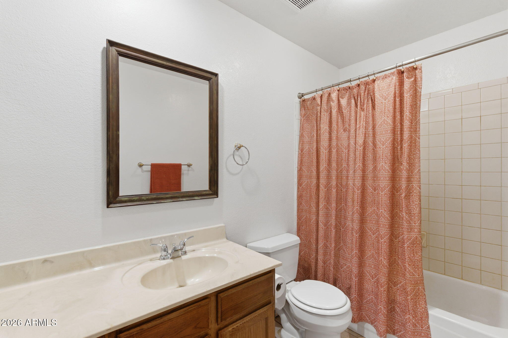 7119 West Ocotillo Road Glendale, AZ 85303 - Photo 22 of 24 a bathroom with a sink a toilet and shower curtain