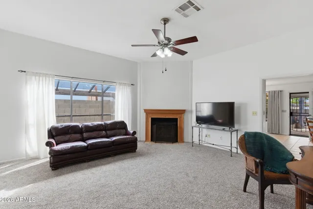a living room with furniture a fireplace and a flat screen tv