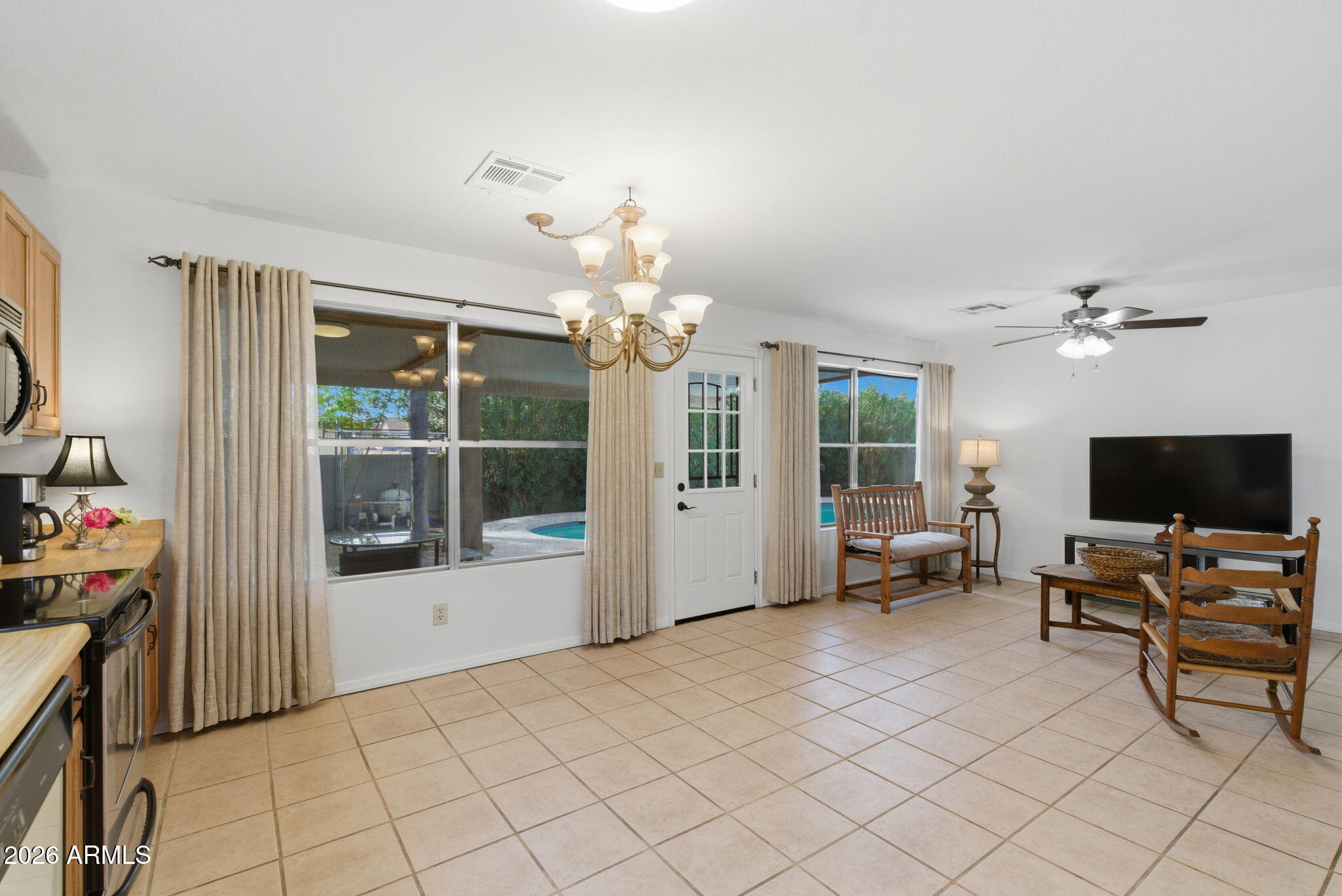 7119 West Ocotillo Road Glendale, AZ 85303 - Photo 9 of 24 a living room with furniture a flat screen tv and a window