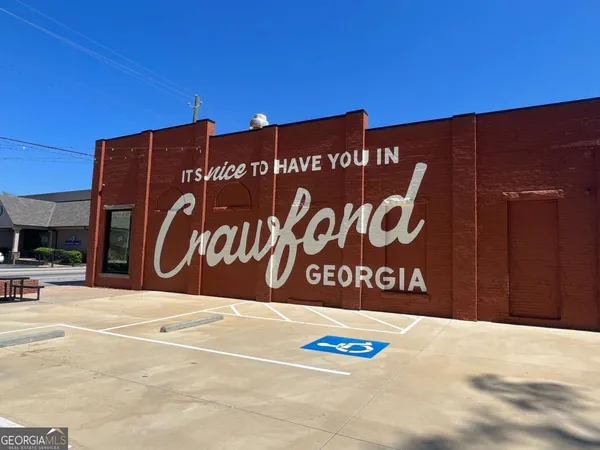 a sign board with a building in the background