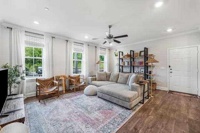a living room with furniture and large windows