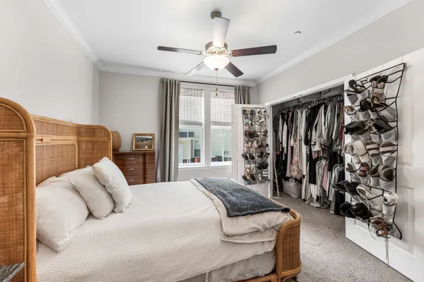 a bedroom with a bed next to a window