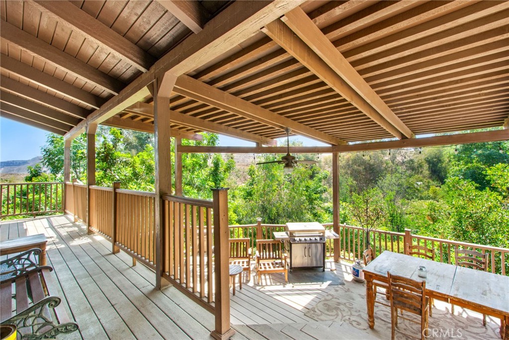 7241 Old Temescal Road Corona, CA 92881 - Photo 17 of 47 a patio with wooden floor a yard tables and chairs