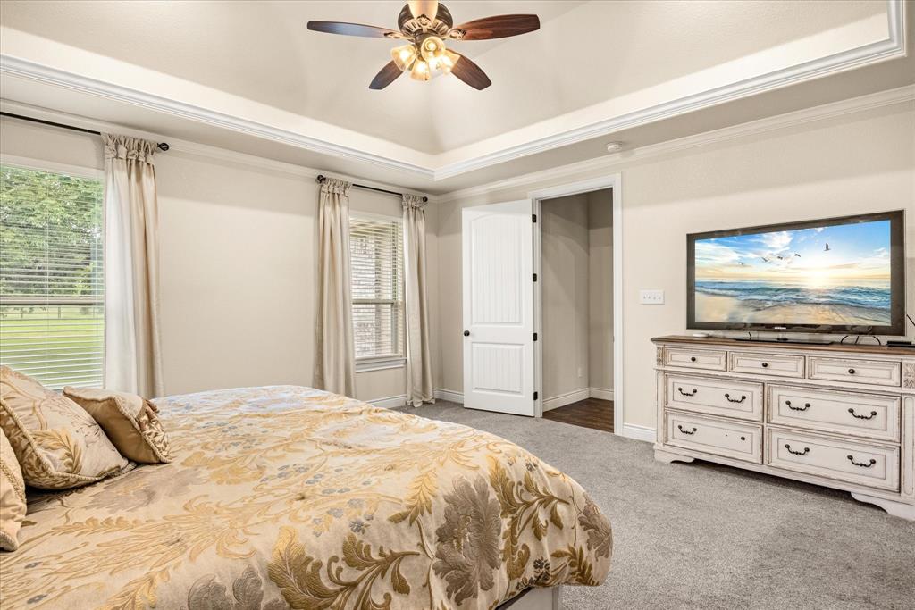 100 Knob Road Springtown, TX 76082 - Photo 14 of 29 a bedroom with a bed and a flat screen tv