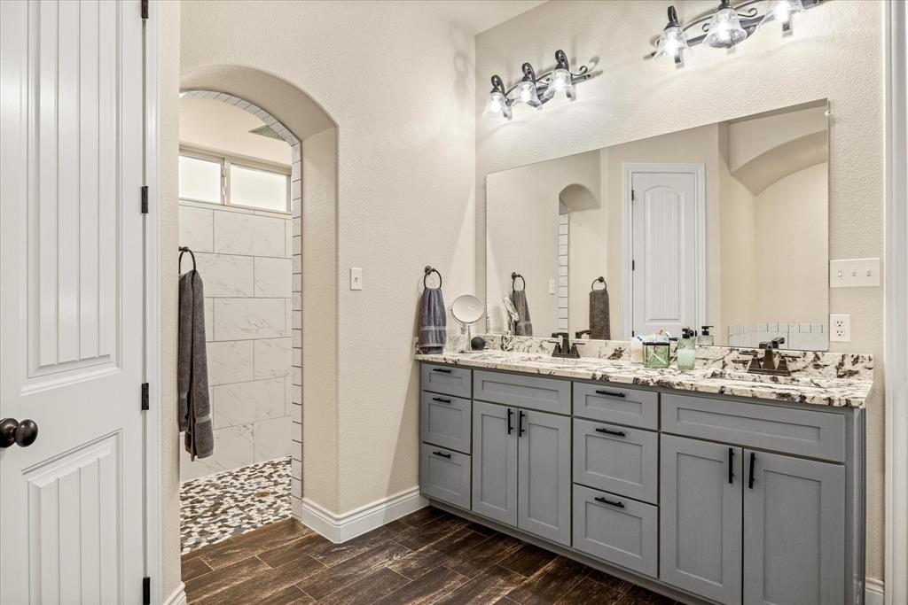 100 Knob Road Springtown, TX 76082 - Photo 15 of 29 a bathroom with a double vanity sink and a mirror
