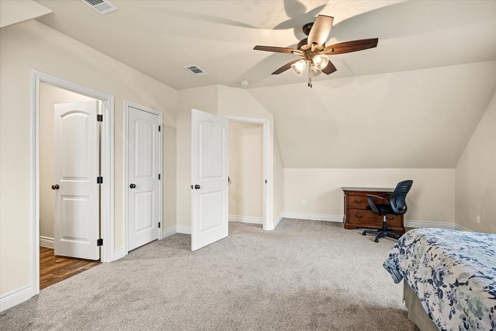 100 Knob Road Springtown, TX 76082 - Photo 23 of 29 a bedroom with a bed and a chair