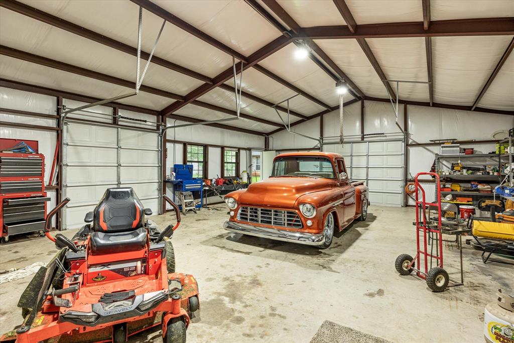 100 Knob Road Springtown, TX 76082 - Photo 27 of 29 a bedroom with furniture and a flat screen tv