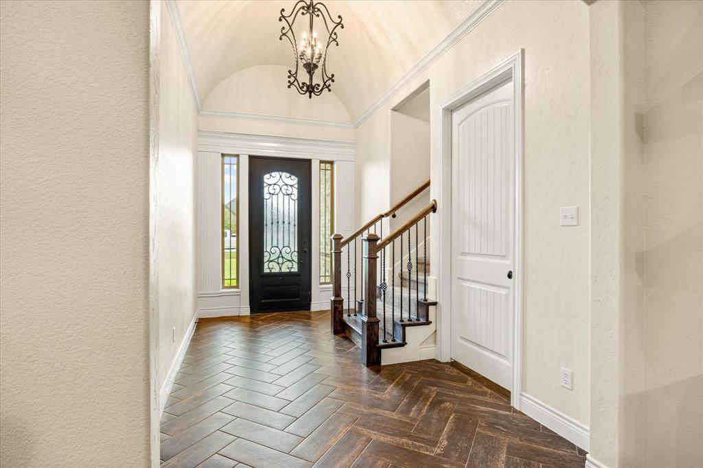 100 Knob Road Springtown, TX 76082 - Photo 3 of 29 a view of a hallway with entryway and chandelier