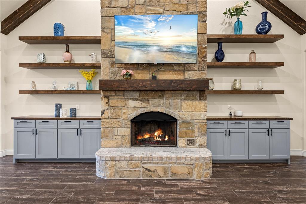 100 Knob Road Springtown, TX 76082 - Photo 6 of 29 a living room with stainless steel appliances granite countertop a fireplace a stove and a oven
