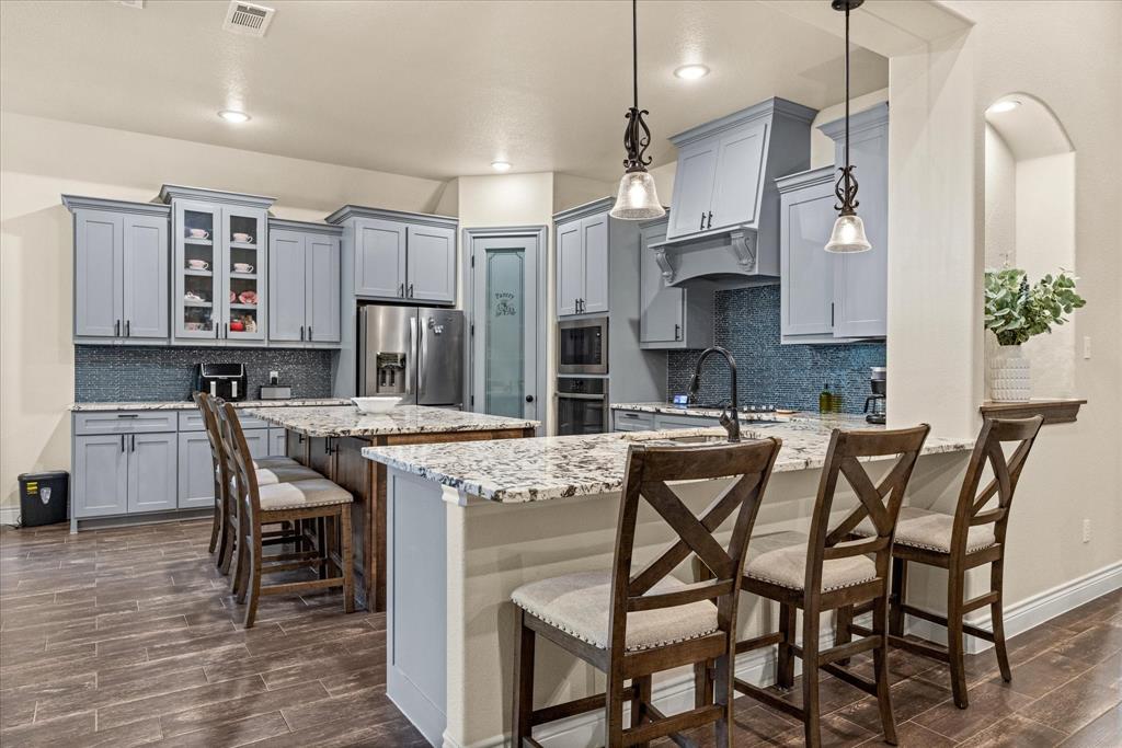 100 Knob Road Springtown, TX 76082 - Photo 8 of 29 a kitchen with stainless steel appliances granite countertop a table chairs sink and cabinets
