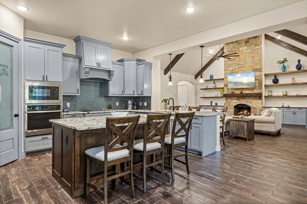 100 Knob Road Springtown, TX 76082 - Photo 10 of 29 a kitchen with a table chairs sink and cabinets