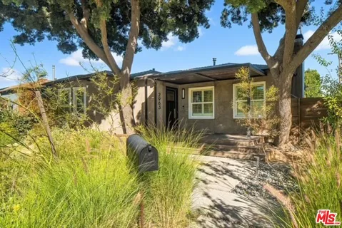 a view of a house with a large tree