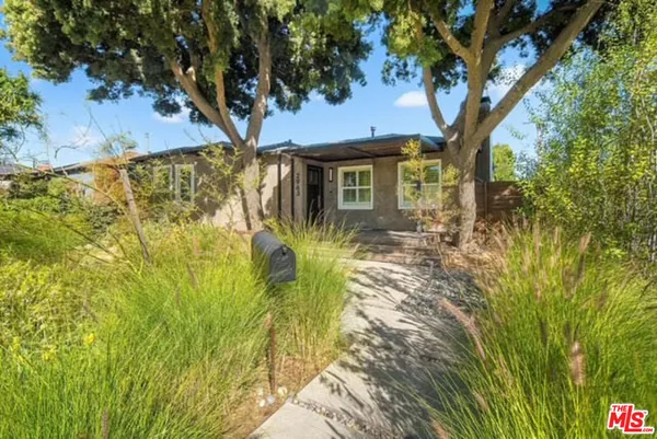a view of a house with a tree