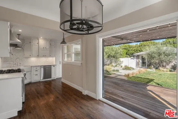 a view of a kitchen with a dishwasher cabinets and a floor to ceiling window