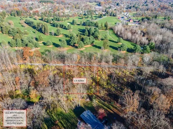 an aerial view of a houses with a yard