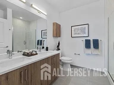 a bathroom with a sink a toilet and mirror