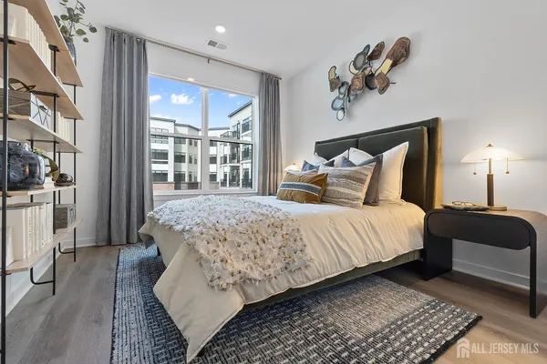 a bedroom with a large bed and a window