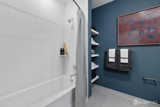 a bathroom with a bathtub and a shower