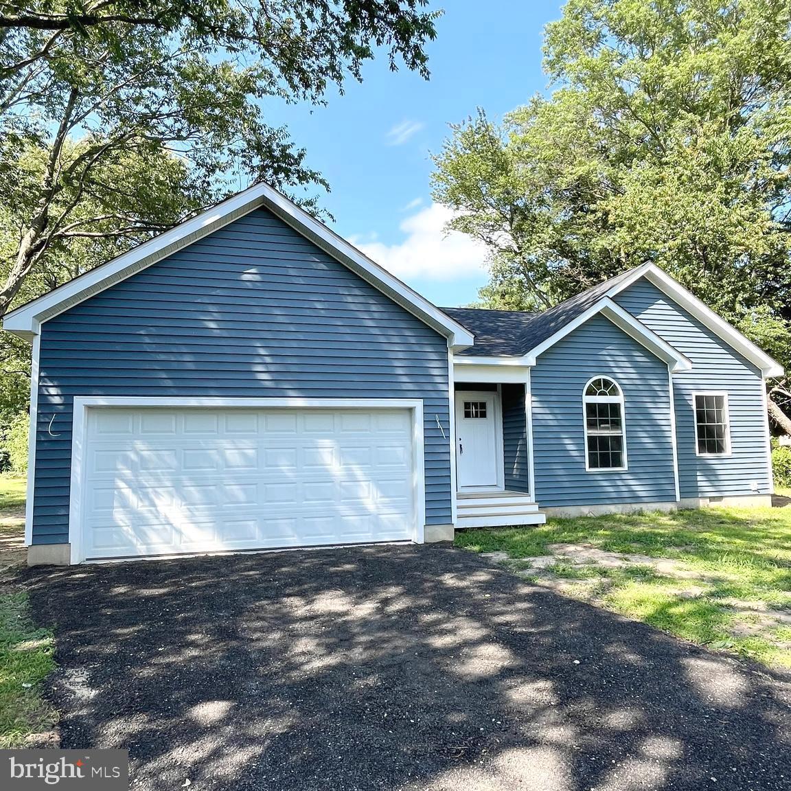 a view of a house with yard and a garden