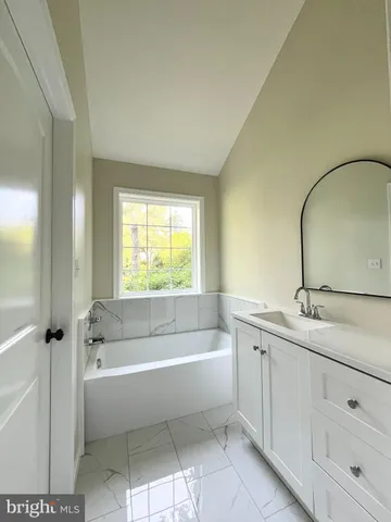 a bathroom with a bathtub and a sink