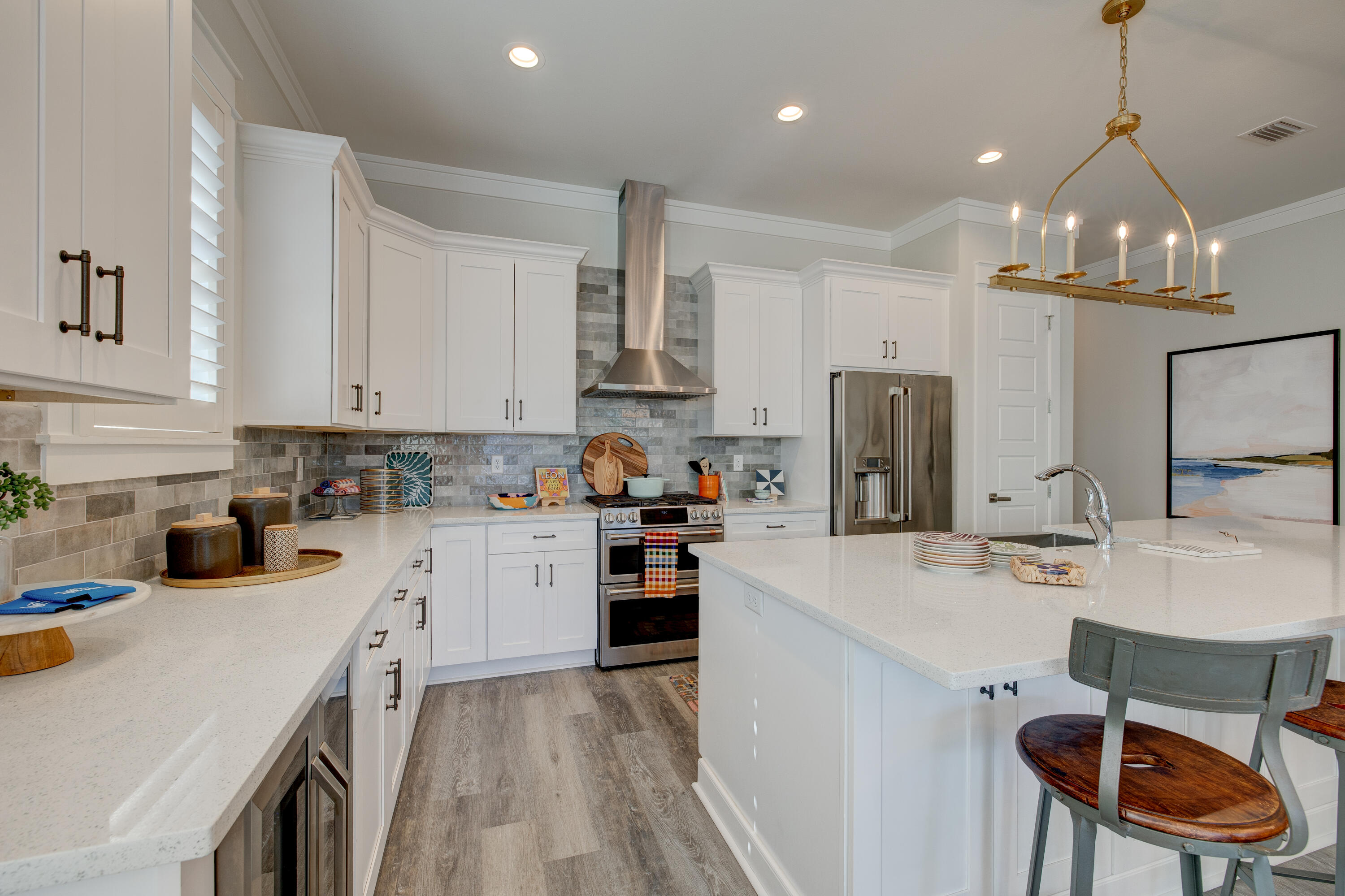 34 Gulfview Way Santa Rosa Beach, FL 32459 - Photo 12 of 54 a kitchen with stainless steel appliances kitchen island granite countertop a sink dishwasher a stove a refrigerator a microwave oven with white cabinets and chairs