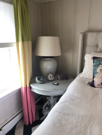 a bedroom with a bed and a window